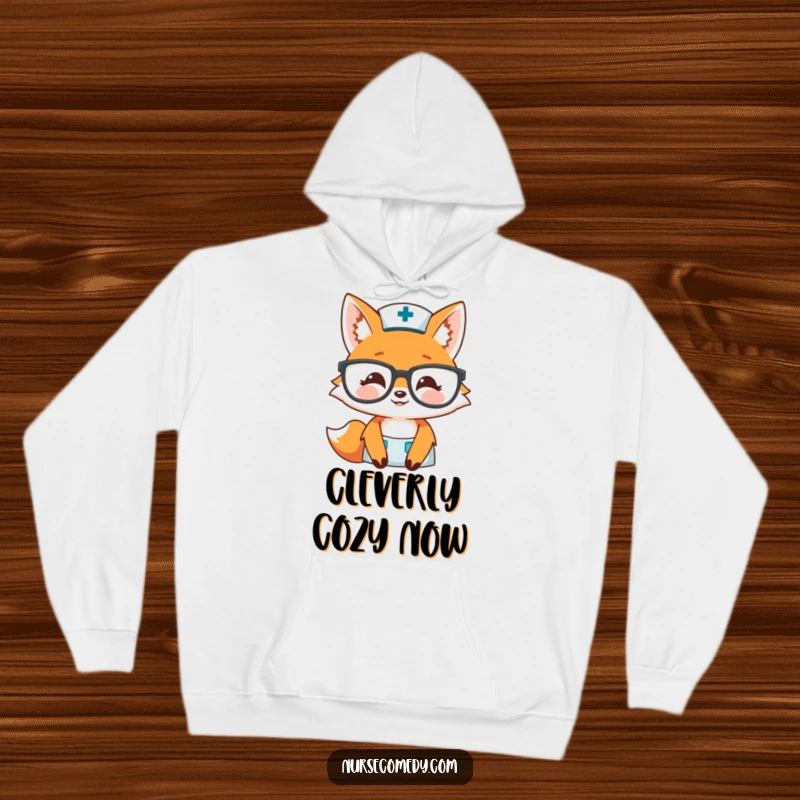 Funny fox nurse hoodie featuring a smiling fox peeking over big glasses, offering warmth and humor, great for gifting.