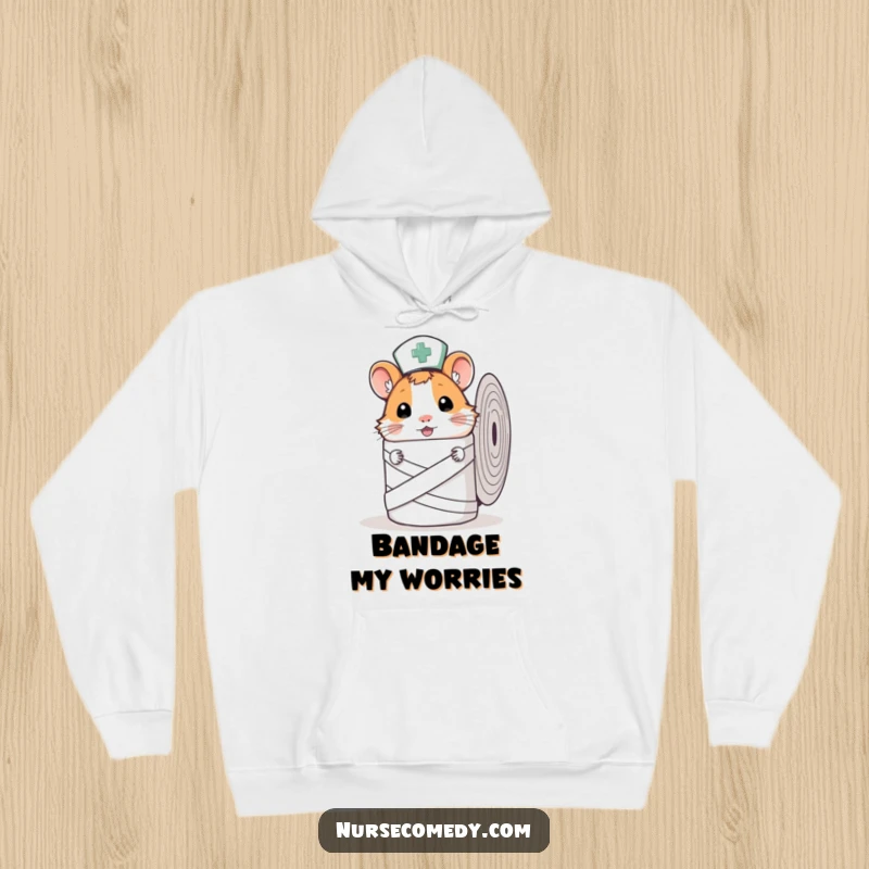 Cozy Funny Hamster Nurse Hoodie with a curious hamster peeking from behind a bandage roll, offering warmth and cuteness.